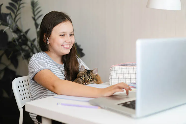 Niña estudiando con su computador