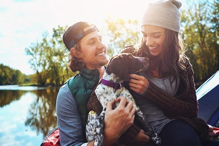 Pareja con mascota haciendo actividades al aire libre