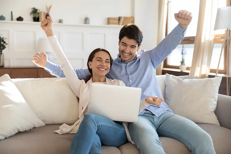 Pareja feliz frente a su computador