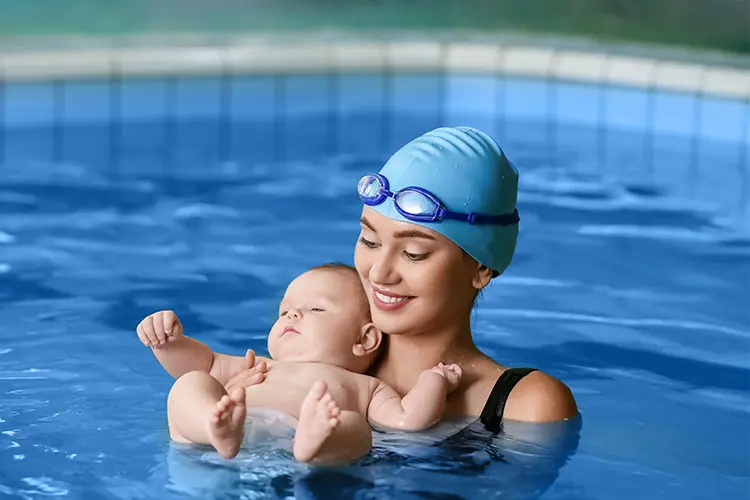 Una madre y su bebé en la piscina participando en las clases de matronatación.