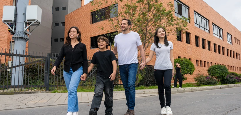 Familia camina frente a una sede de Colsubsidio.